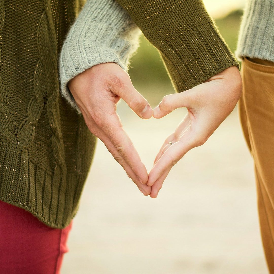 Two hands forming a heart shape, symbolising love and affection.